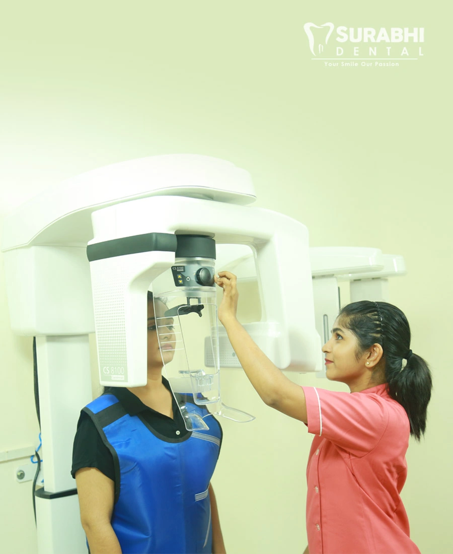 best-dental-clinic-kerala-xray-machine Dentist operating a dental X-ray machine with patient at Best Dental Clinic in Ernakulam, Kerala